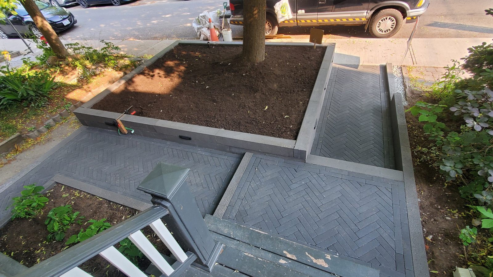 The new paver walkways and raised garden viewed from the porch