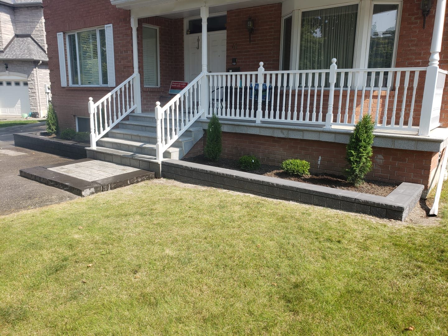 Dark capped garden walls frame the front porch